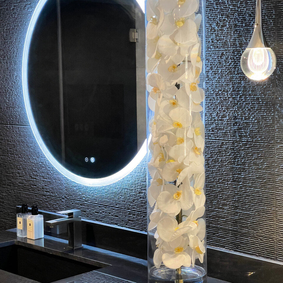 Cylindre de verre contenant des orchidées Phalaenopsis blanches